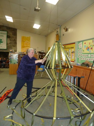 Greenwood faculty member Annie Quest works on Yellow Barn's "Mad King" cages